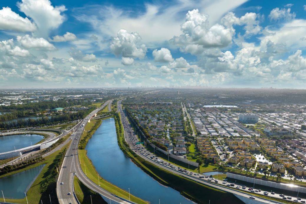 aerial view of freeway intersection with cars and trucks in miami
